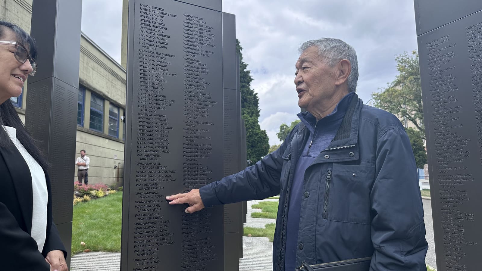 Henry Wakabayashi points to his name on the monument
